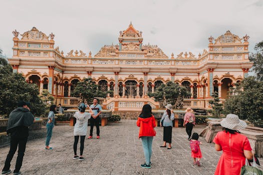 Visitors exploring the historic Vinh Trang Temple, a famous landmark in Vietnam.